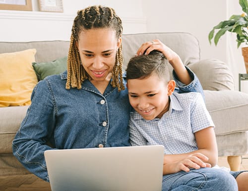 Mother and son working together with their laptop